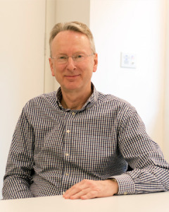 Simon Brennan sitting at a desk