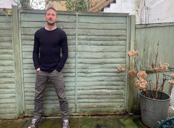 Author James standing in a garden