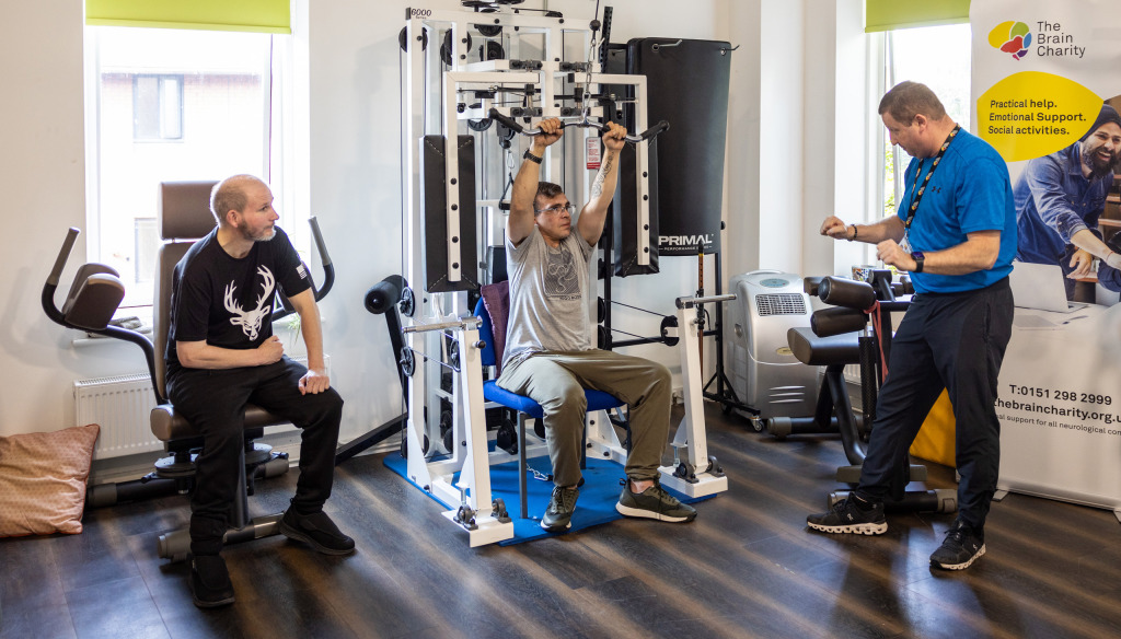 People using gym equipment in The Brain Charity's Neuro Gym