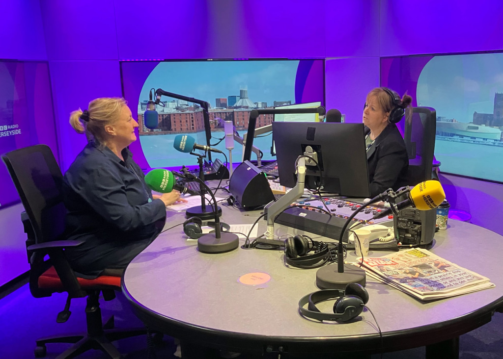 Pippa Sargent in a radio studio being interviewed by the host