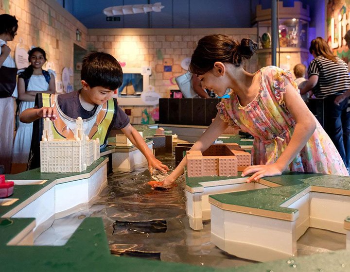 Children playing with a model of Liverpool docks at the museum