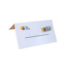 Side view of wedding favour place card with The Brain Charity logo and detachable pin badge