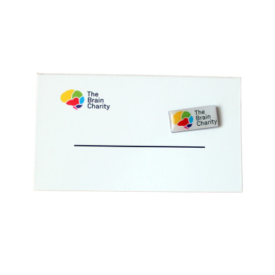 Front of the card with The Brain Charity logo and detachable pin badge