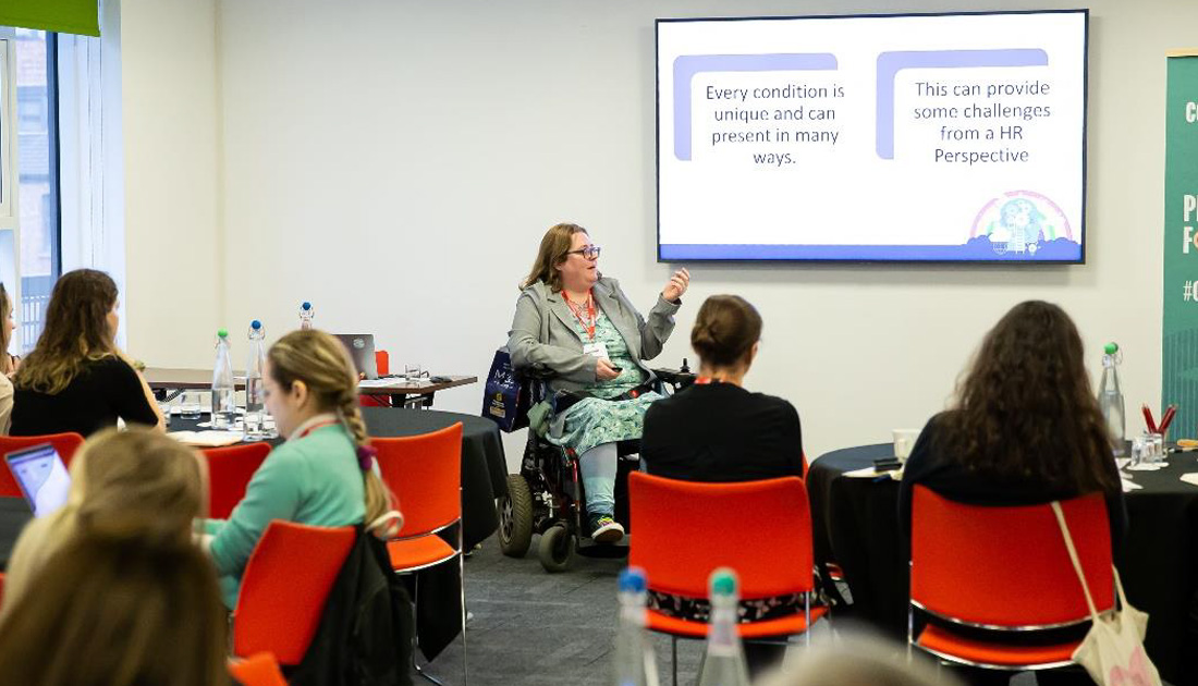 A woman in a wheelchair teaches a class