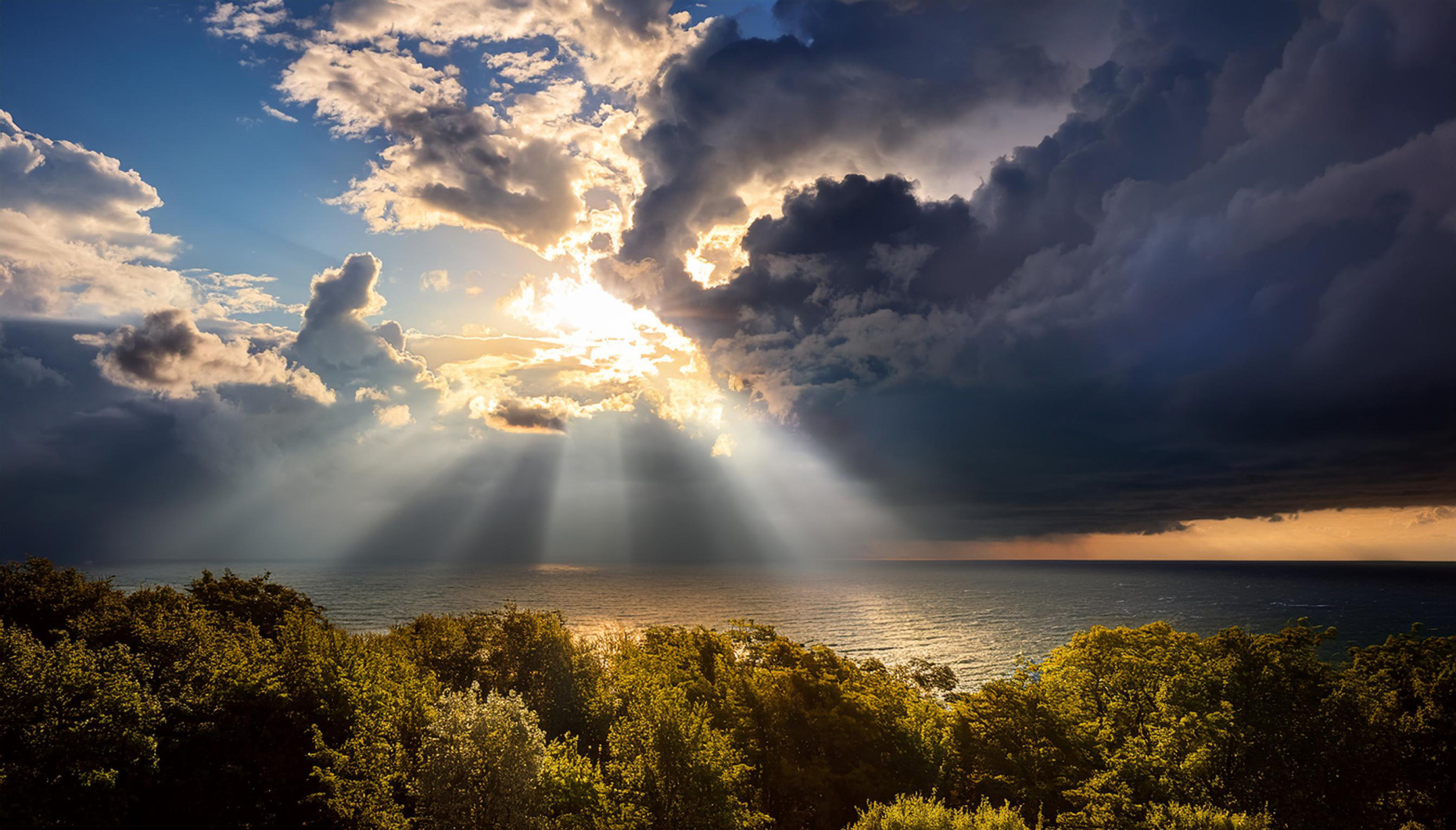 Sunlight emerging from clouds over the sea