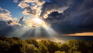 Sunlight emerging from clouds over the sea