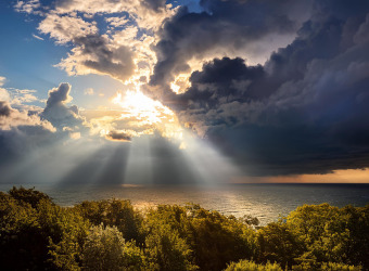 Sunlight emerging from clouds over the sea