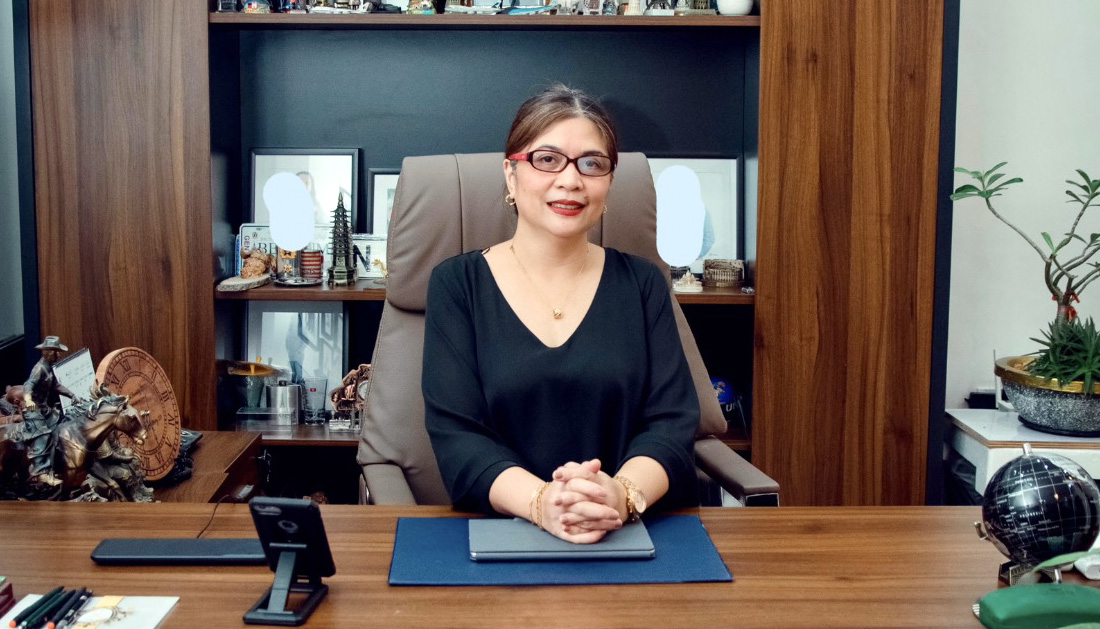 Beverly sitting at a desk in her office