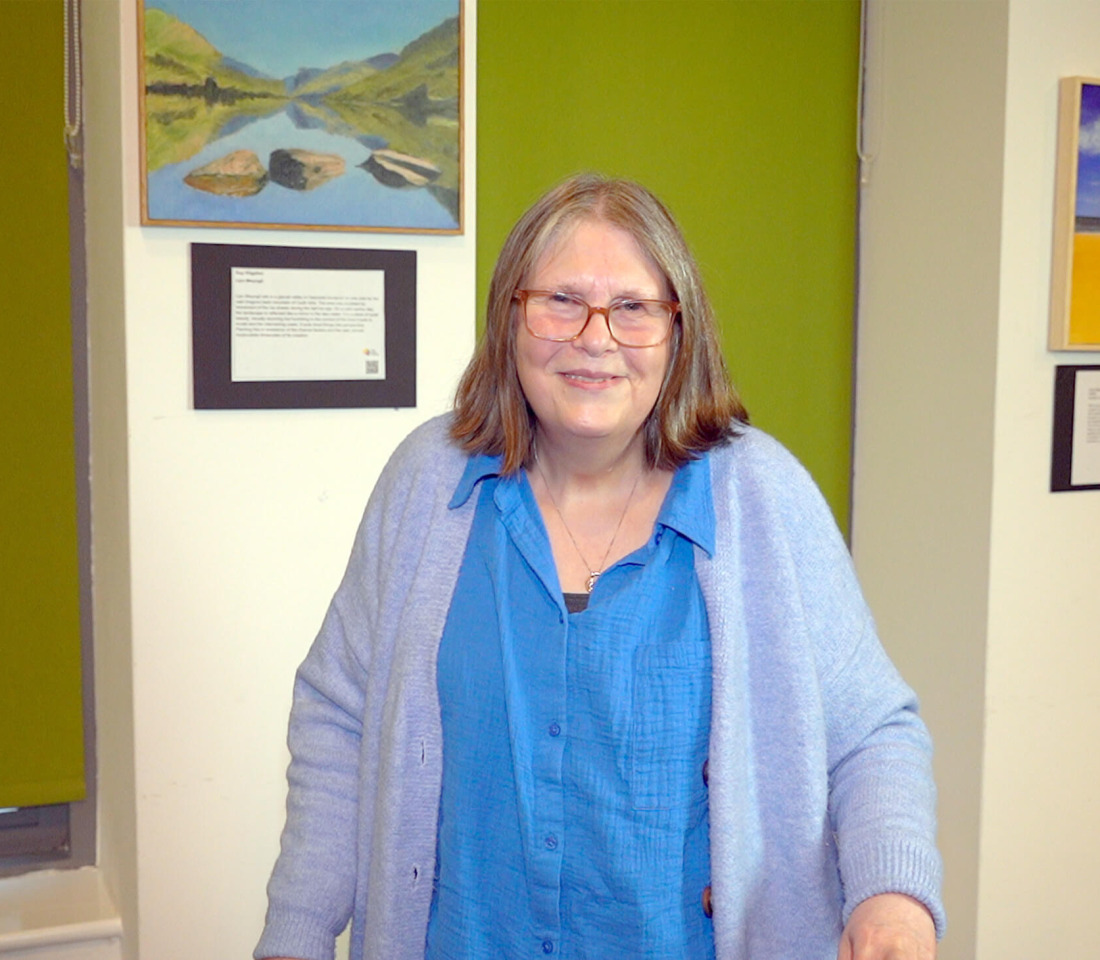 Christine, a middle-aged woman in a cardigan, on a visit to The Brain Charity