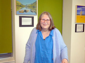 Christine, a middle-aged woman in a cardigan, on a visit to The Brain Charity