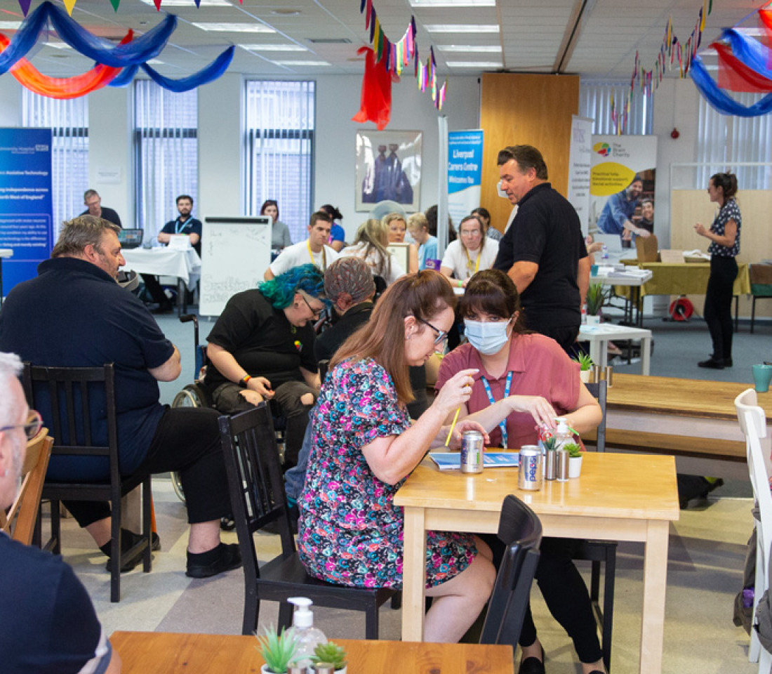 A wide shot of people enjoying friendship and coffee in The Brain Charity cafe