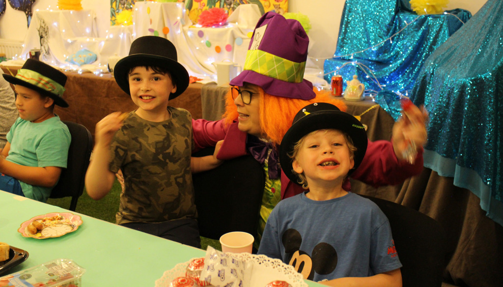 Children enjoying a Mad Hatter's tea party