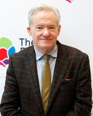 Trustee Gus Baker in jacket and tie