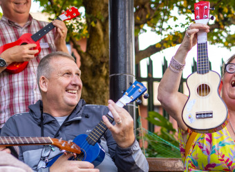 Ukulele players outside at The Brain Charity